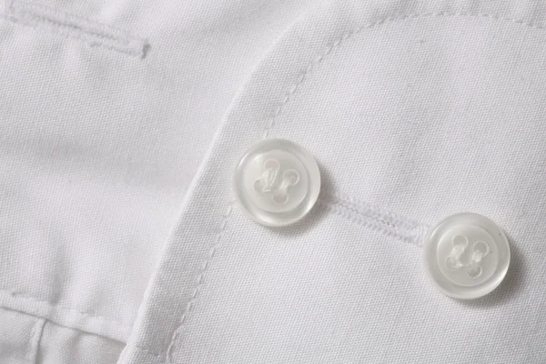 Boutons sur tissu blanc — Photo