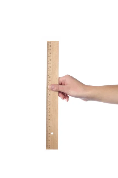 Hand holding wooden ruler — Stock Photo, Image