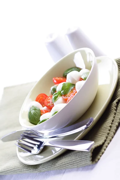 Tomatoes and mozarella in dish — Stock Photo, Image