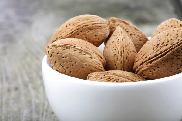Brown almonds in shells — Stock Photo, Image