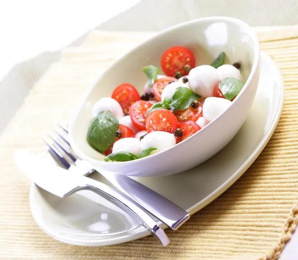 Tomatoes and mozarella in dish — Stock Photo, Image