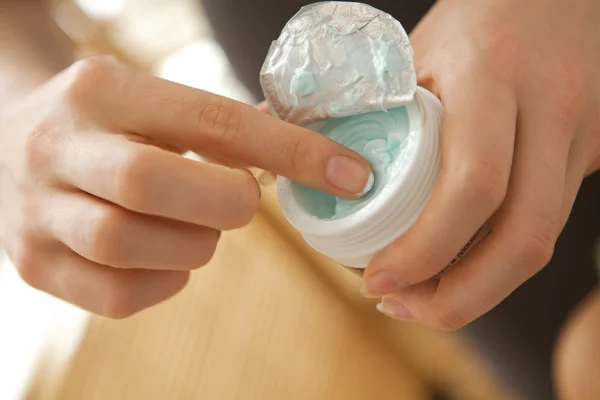 Woman holding facial cleanser — Stock Photo, Image