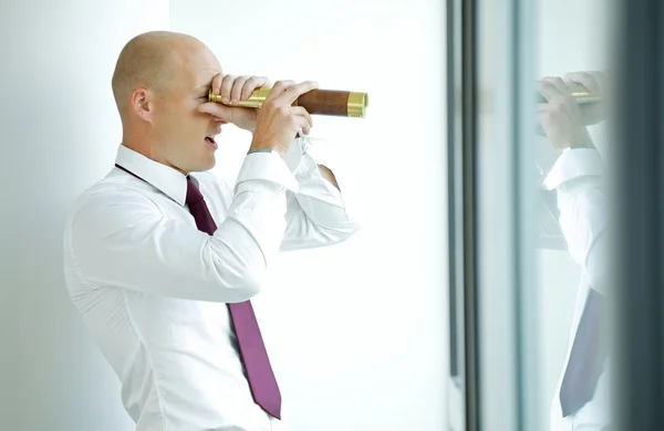 Businessman spying using telescope — Stock Photo, Image