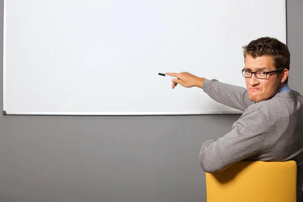 Businessman pointing at whiteboard — Stock Photo, Image