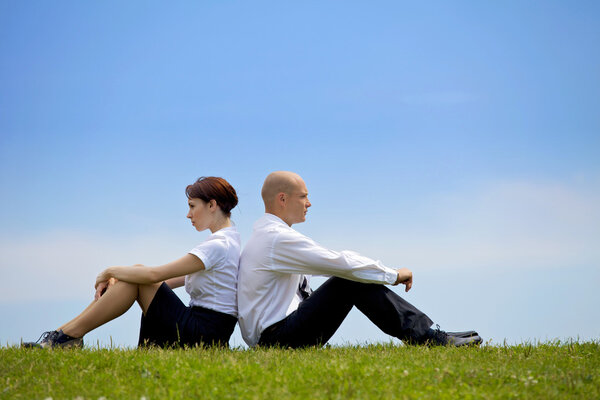 couple sitting back to back