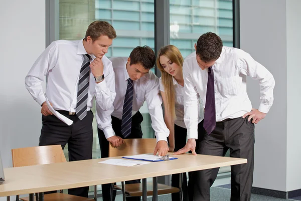 Business team looking at document — Stock Photo, Image