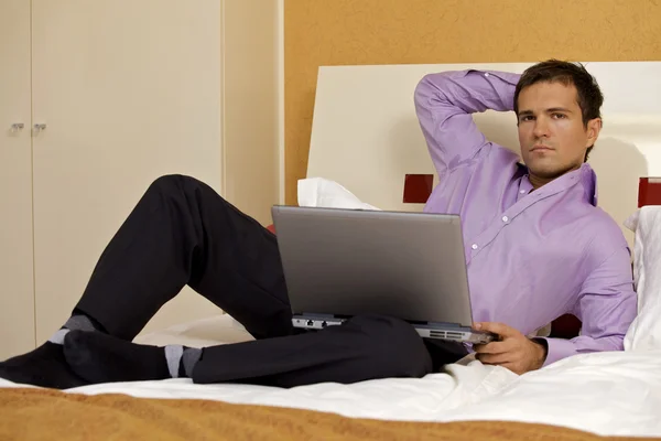 Man with laptop lying — Stock Photo, Image