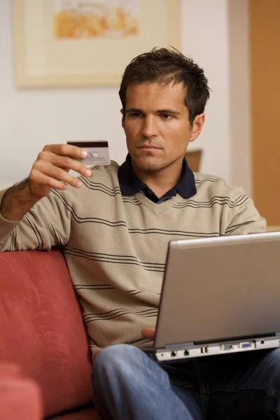 Young man holding credit card — Stock Photo, Image