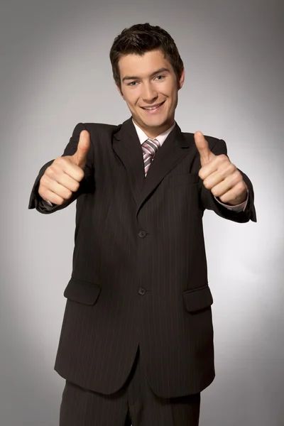 Businessman showing thumbs up  gesture — Stock Photo, Image