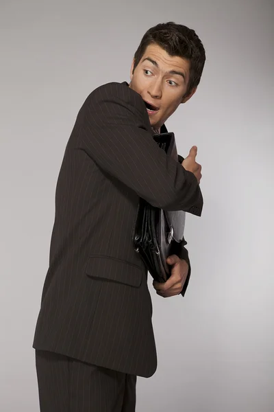 Businessman defending his briefcase — Stock Photo, Image