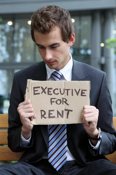 Businessman with executive for rent sign