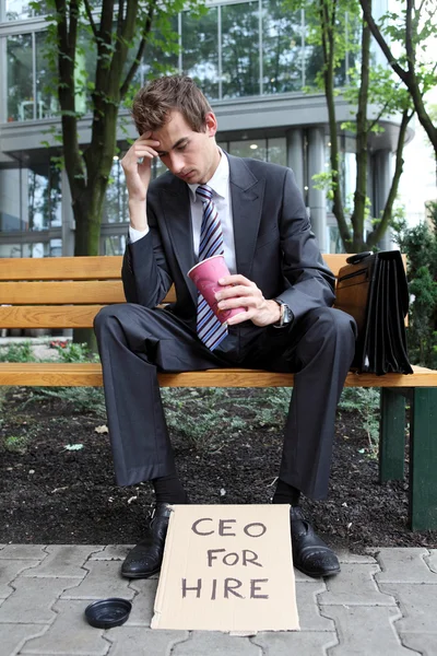 Businessman with ceo for hire sign — Stock Photo, Image