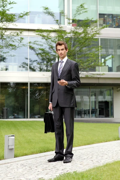 Businessman holding cellphone — Stock Photo, Image