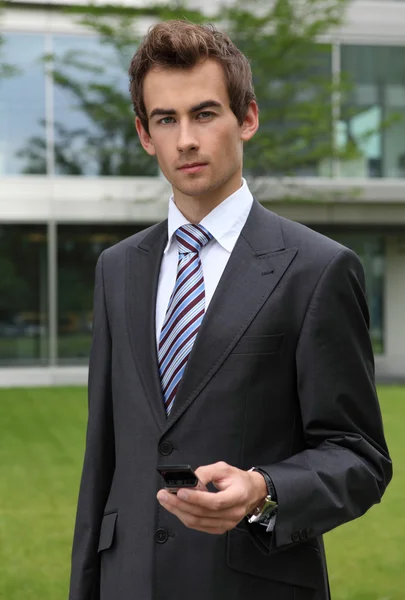 Businessman holding cellphone — Stock Photo, Image