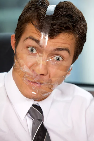 Businessman with tape on his face — Stock Photo, Image