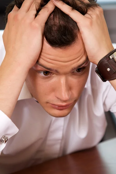 Businessman with head in hands — Stock Photo, Image