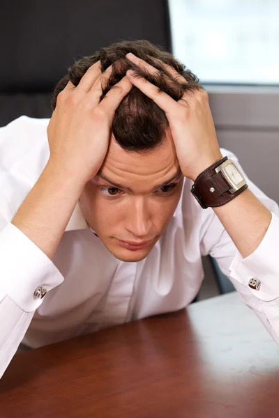 Businessman with head in hands — Stock Photo, Image