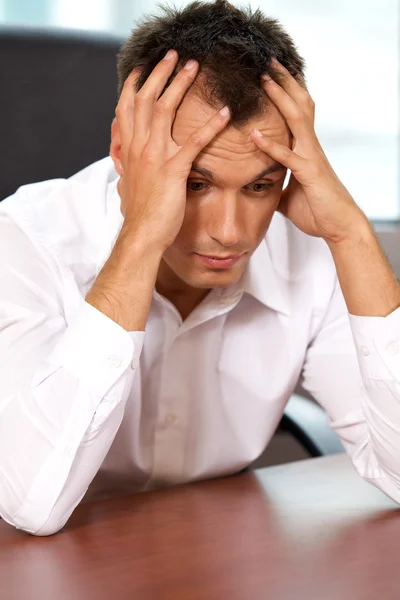 Businessman with head in hands — Stock Photo, Image