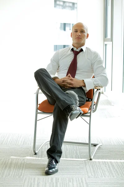 Businessman sitting on chair — Stock Photo, Image