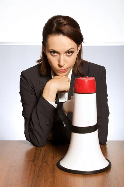 Young businesswoman with megaphone — Stock Photo, Image