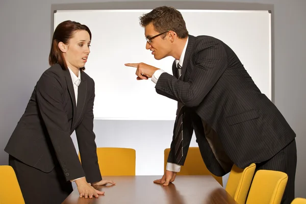 Businessman pointing towards businesswoman — Stock Photo, Image