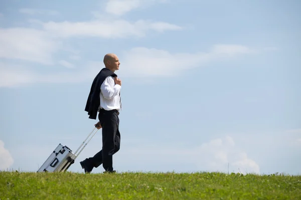 Businessman carrying luggage — Stock Photo, Image