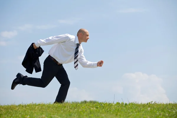 Businessman running in park — Stock Photo, Image