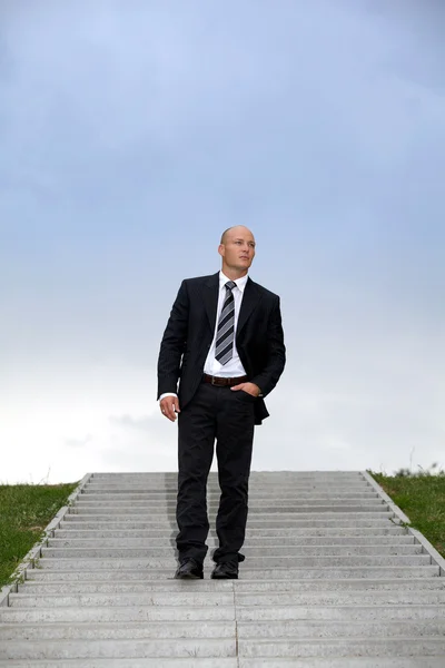 Businessman standing on steps — Stock Photo, Image