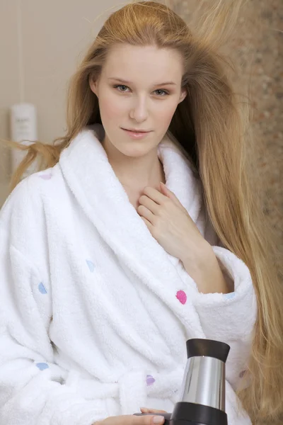Mulher usando um secador de cabelo — Fotografia de Stock