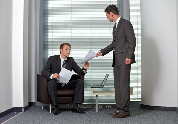 Businessman giving paper — Stock Photo, Image