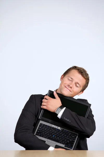 Businessman embracing laptop, — Stockfoto