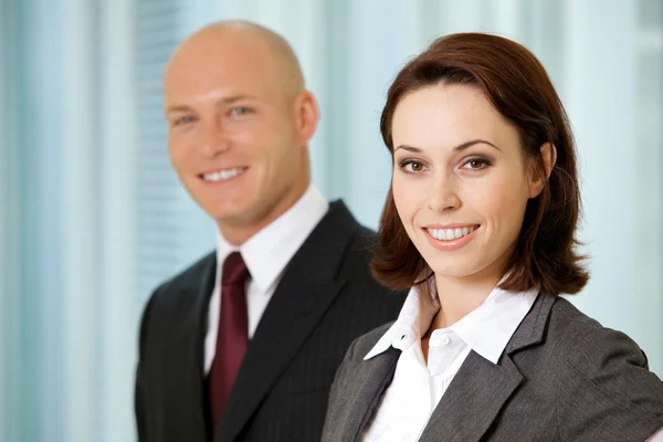 Businessman and businesswoman smiling Stock Image