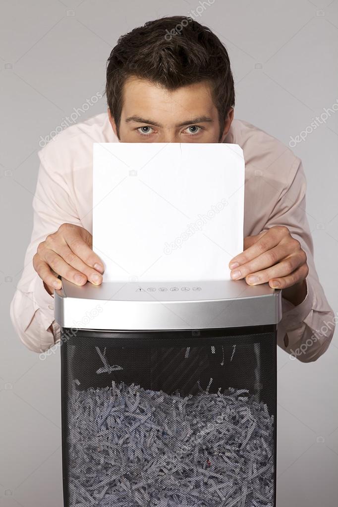 businessman shredding documents