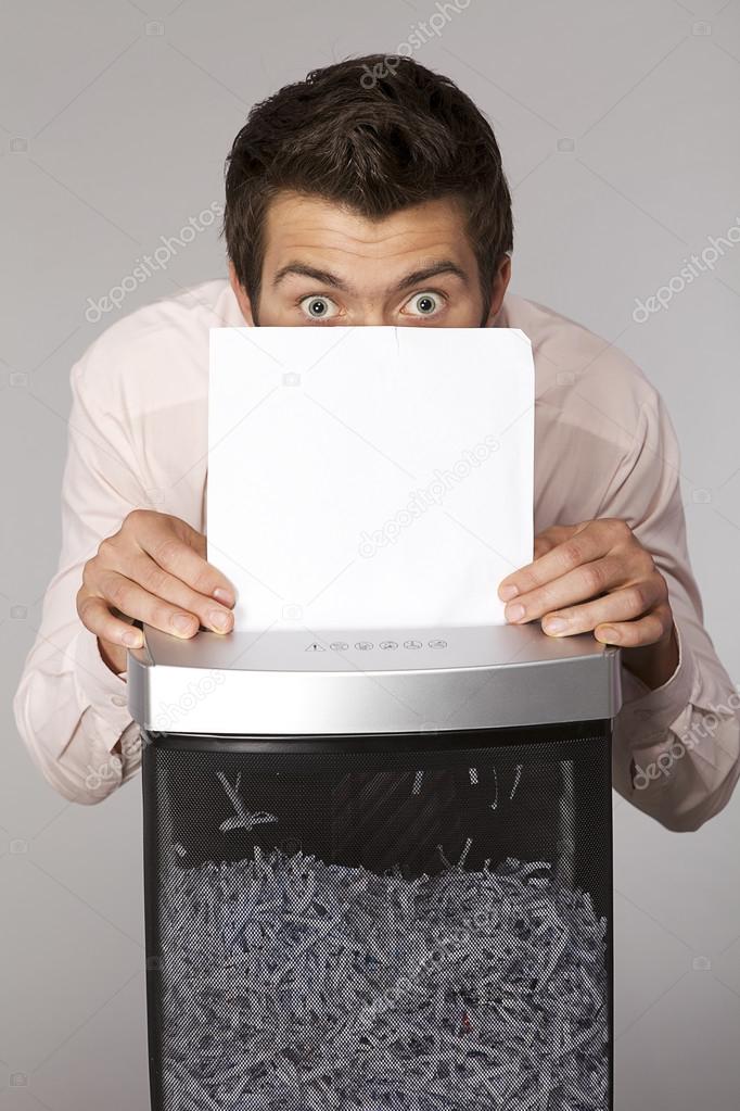 businessman shredding documents
