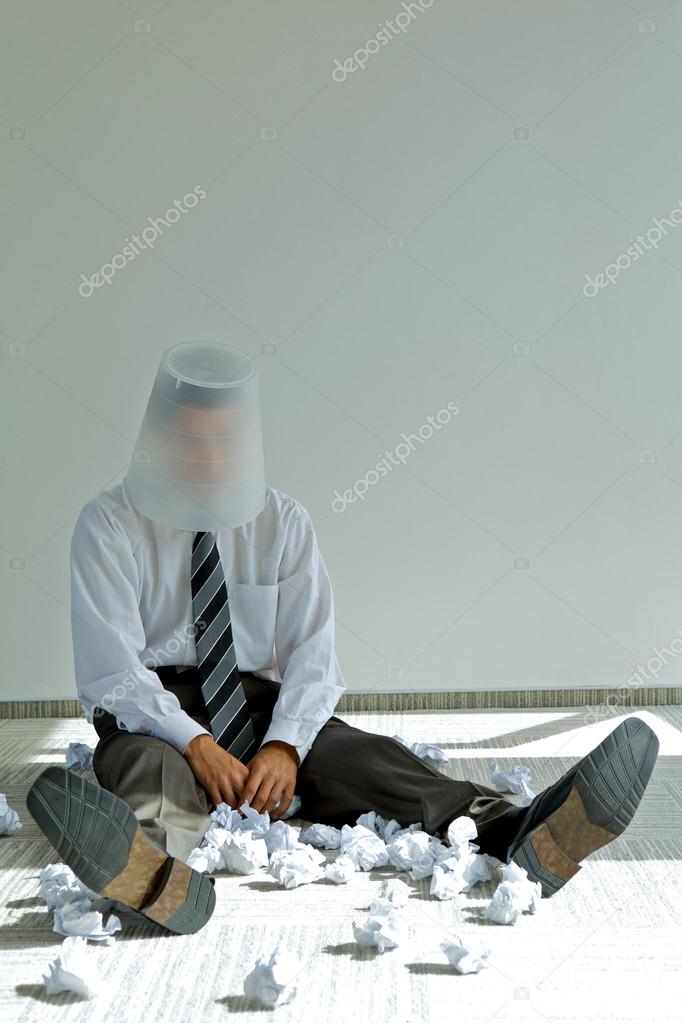 Businessman with bin on his head