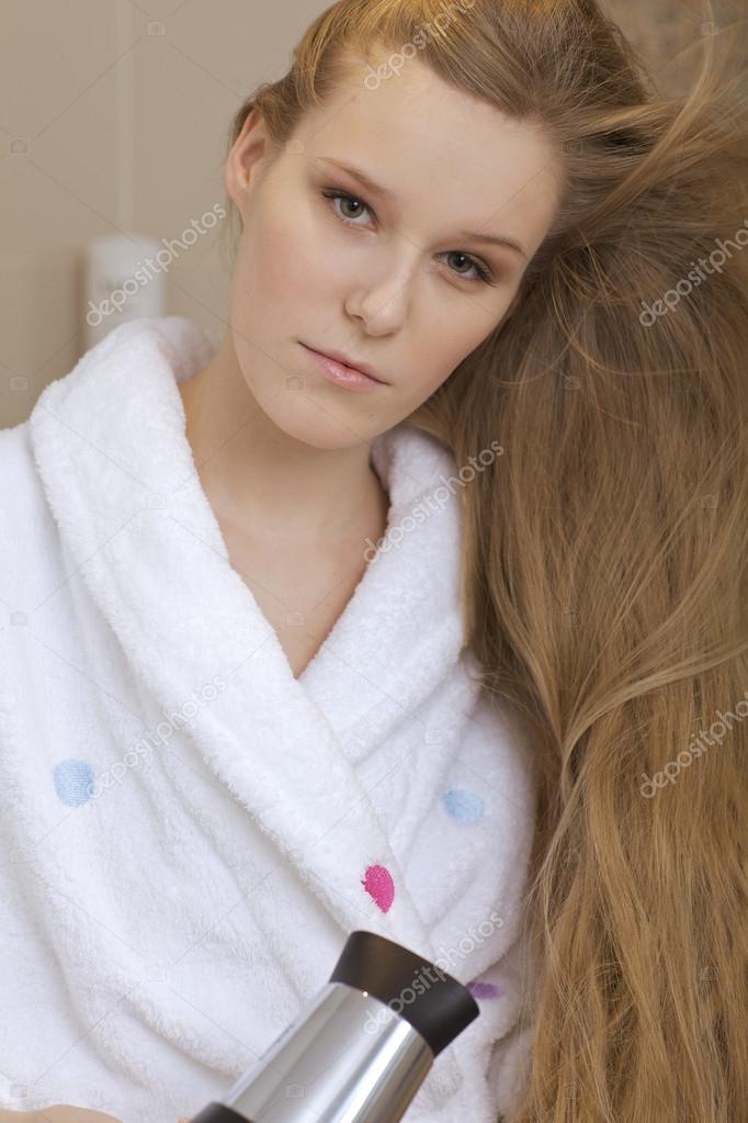 Woman using a hairdryer