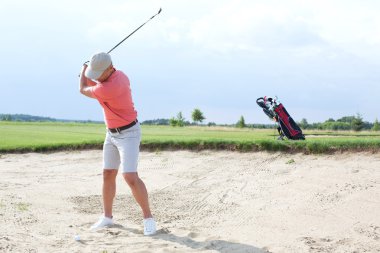 Man swinging at golf course