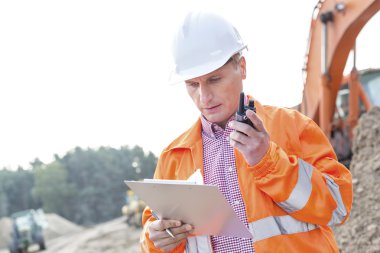 Supervisor reading clipboard