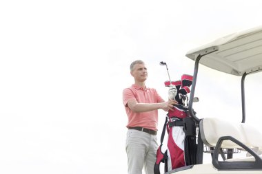 man standing by cart