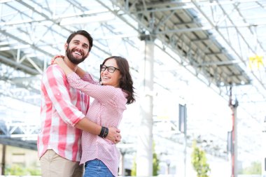couple embracing outside building