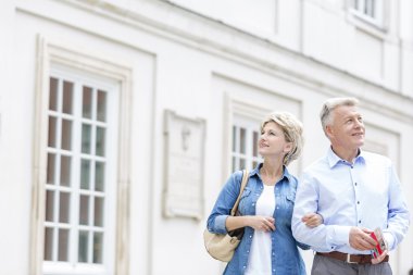couple standing with arm in arm