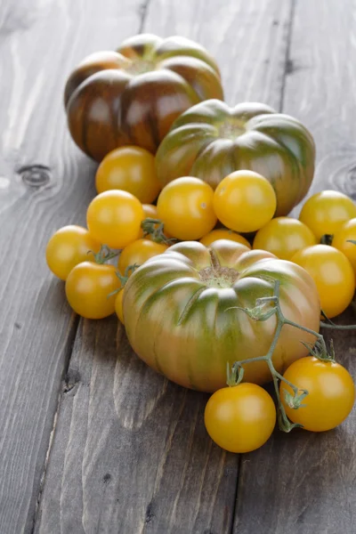 Tomatoes on wooden table — Stock Photo, Image