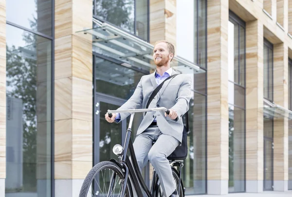 Businessman riding bicycle — Stock Photo, Image