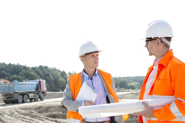 Engineers discussing at construction site — Stock Photo, Image