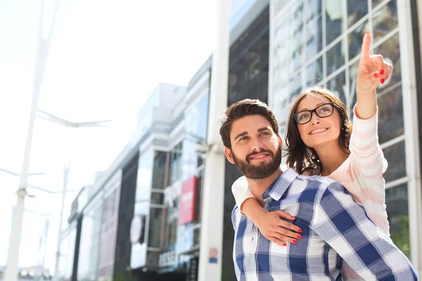 Smiling woman pointing away — Stock Photo, Image