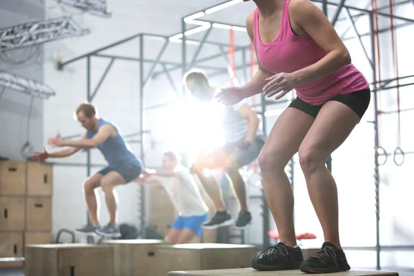 People doing box jump — Stok fotoğraf