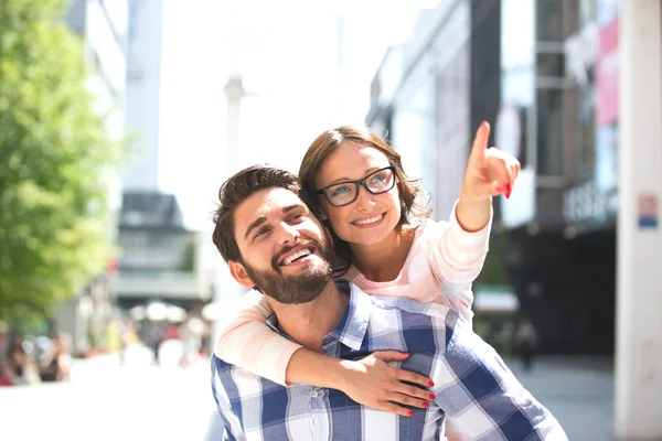 Cheerful woman pointing away — Stockfoto