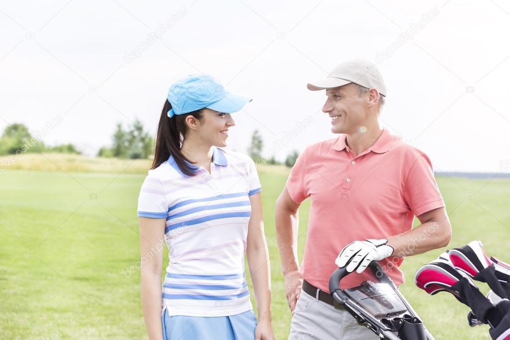 male and female golfers communicating