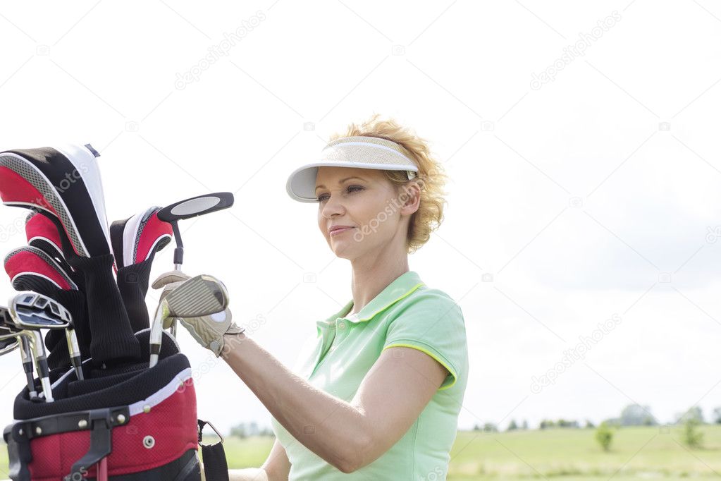 golfer with golf club bag