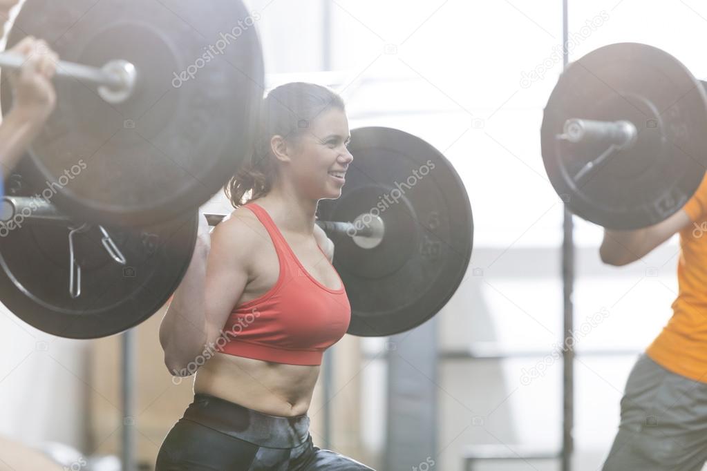 woman lifting barbell
